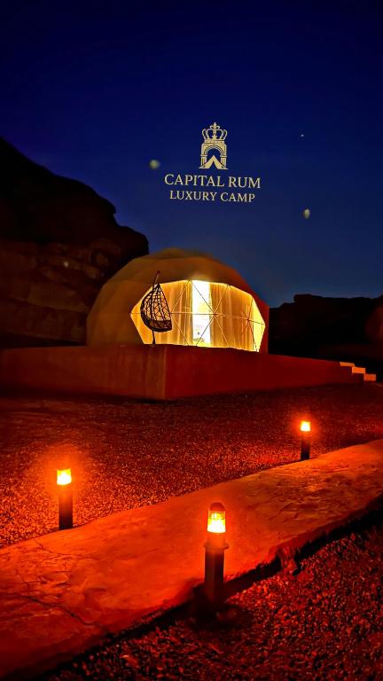 a building with two candles in front of it at night at CAPITAL RUM lUXURY CAMP in Wadi Rum