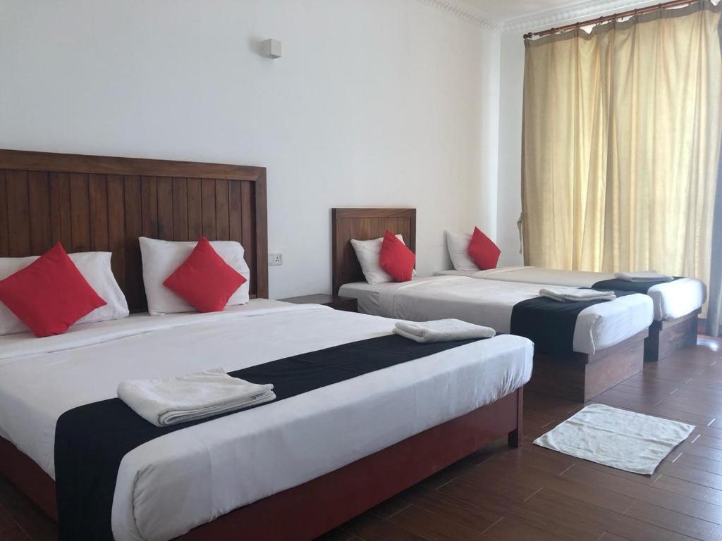 Postel nebo postele na pokoji v ubytování Capital Wind Beach Cabanas