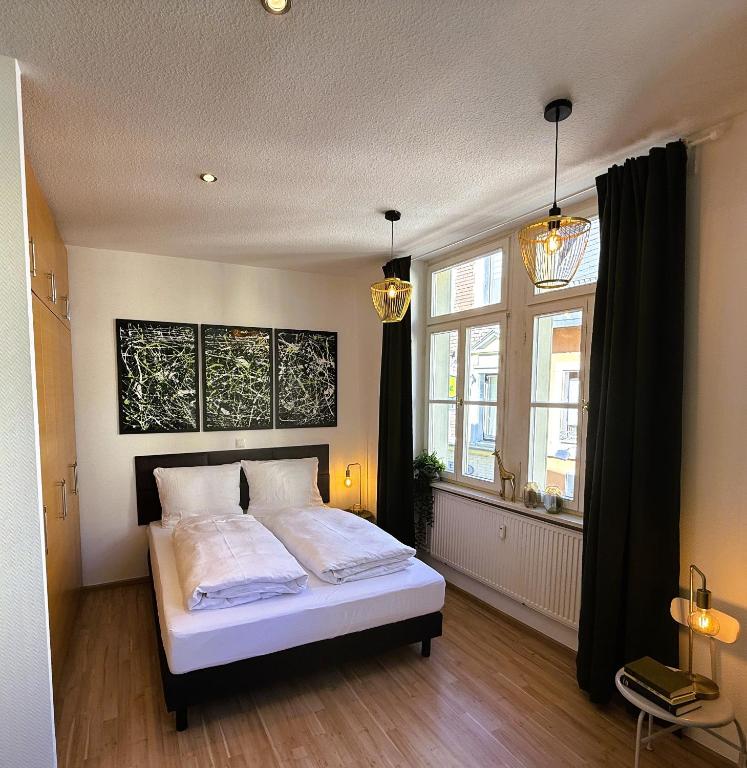 a bedroom with a bed and a large window at Gemütliches Apartment im Zentrum Andernach in Andernach