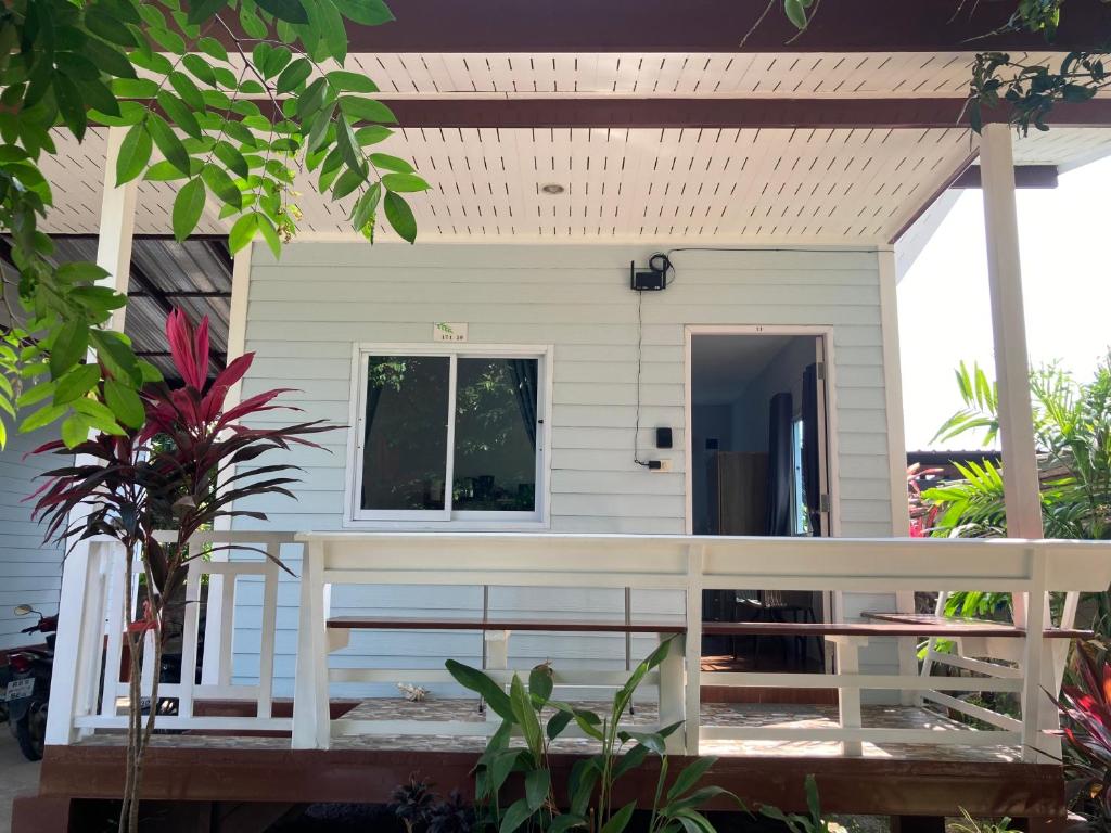 a small white house with a porch at Seasalt 1 Cozy Studio with Full kitchen and fast WiFi in Thong Sala
