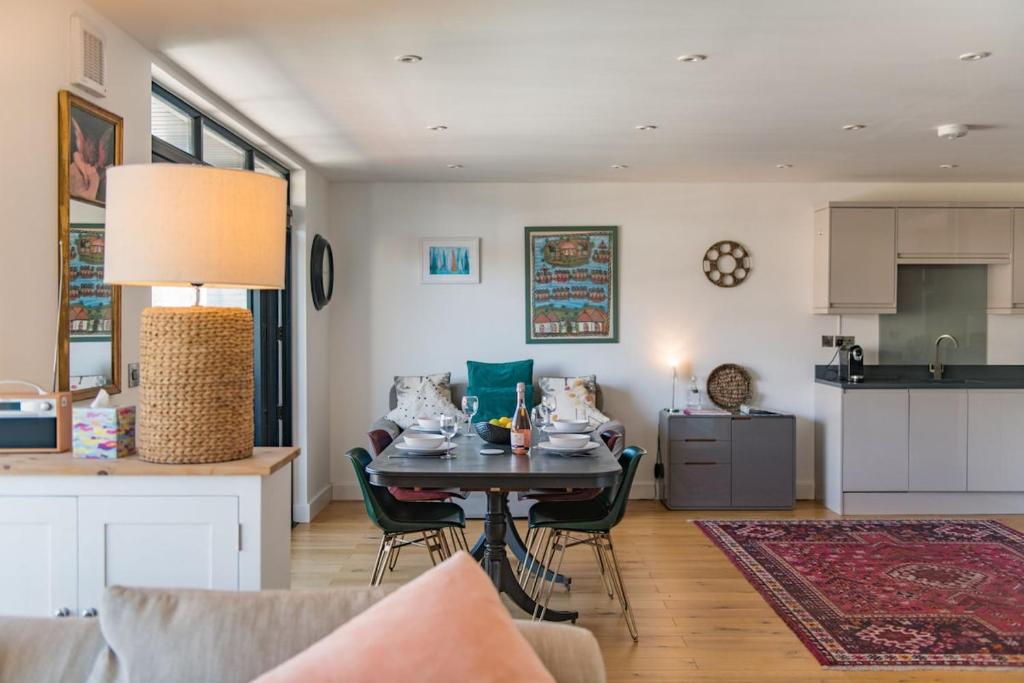 a kitchen and living room with a table and chairs at Bun Penny Apartment by Keepers Cottages in Herne Bay