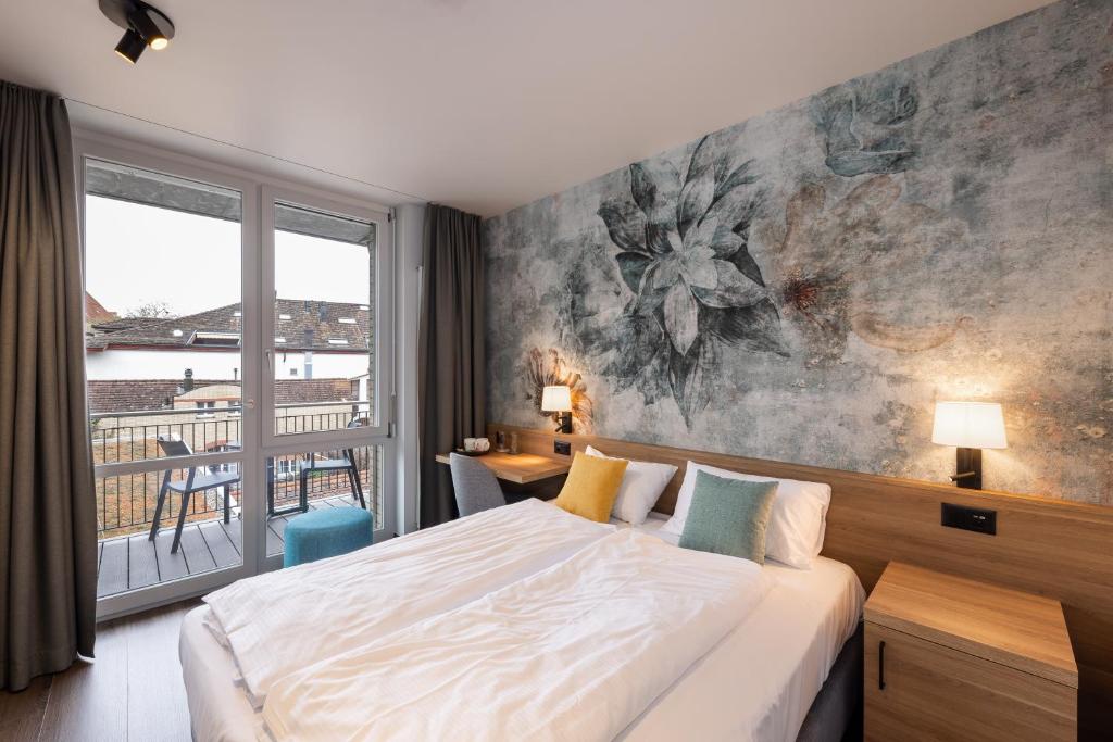 Ένα ή περισσότερα κρεβάτια σε δωμάτιο στο Hotel Loge