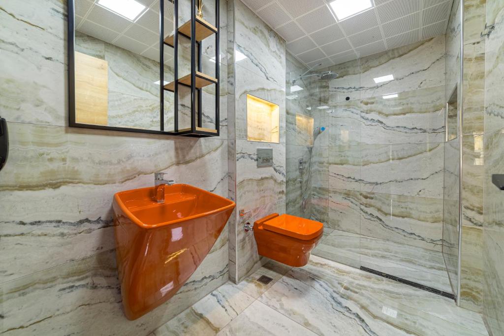 a bathroom with an orange sink and a toilet at Aria Riva Apart Hotel in Alanya