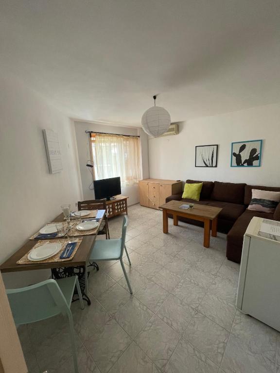 a living room with a table and a couch at Bonne Chance Apartment Sozopol in Sozopol