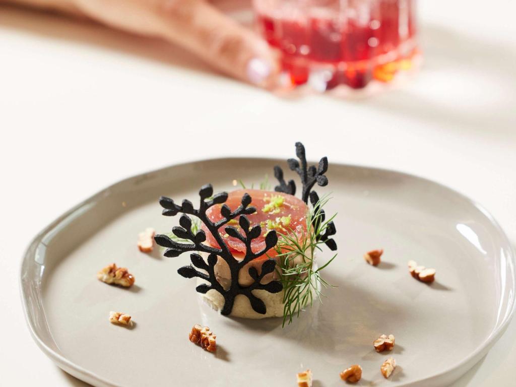 a plate with a dessert with a tree on it at Sofitel Golfe d'Ajaccio Thalassa Sea & Spa in Ajaccio