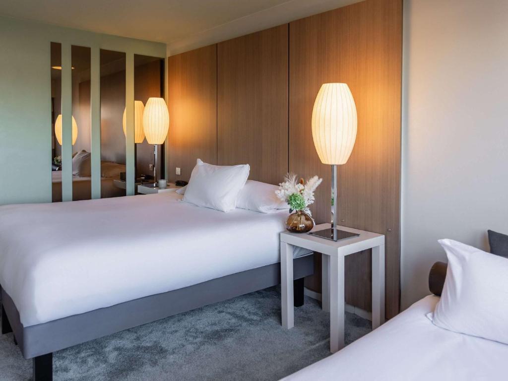 Postel nebo postele na pokoji v ubytování Pullman Bordeaux Lac