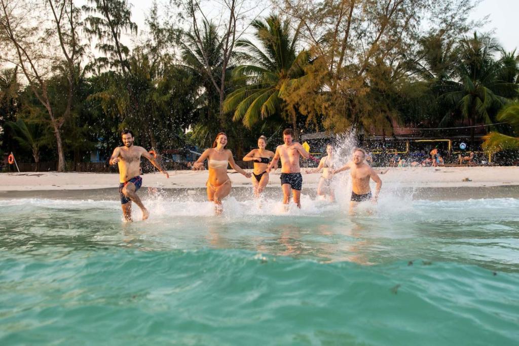 a group of people in the water at the beach at Mad Monkey Koh Rong in Koh Rong Island