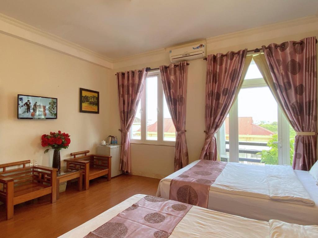 Postel nebo postele na pokoji v ubytování Dai Long Hotel