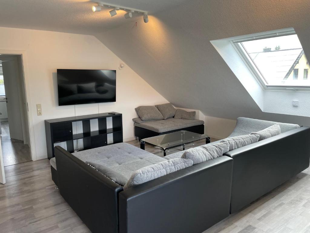 a living room with a couch and a tv at Eastside-Apartment WHG 01 in Senftenberg