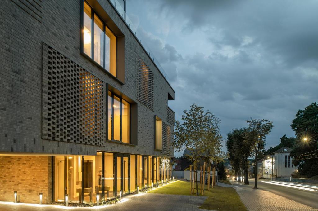 a brick building with windows on a street at Cosy hill in Kaunas