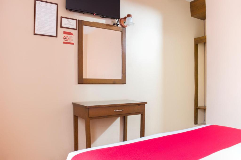 Postel nebo postele na pokoji v ubytování OYO Hotel Museo