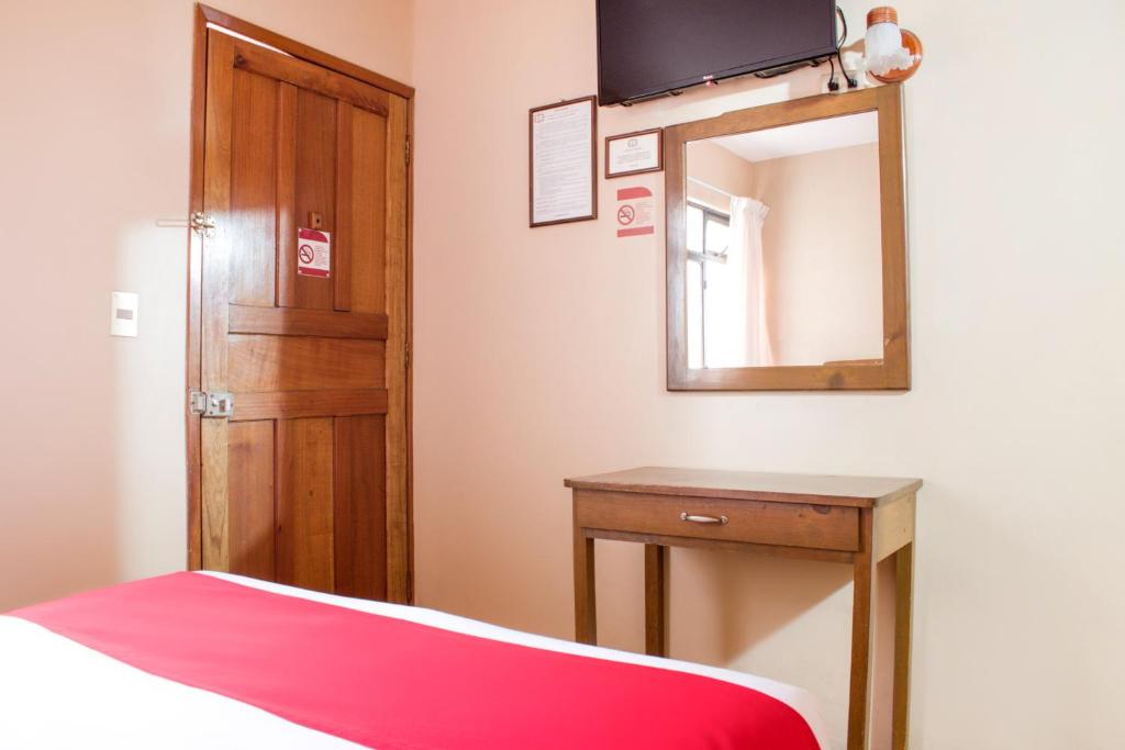 TV a/nebo společenská místnost v ubytování OYO Hotel Museo
