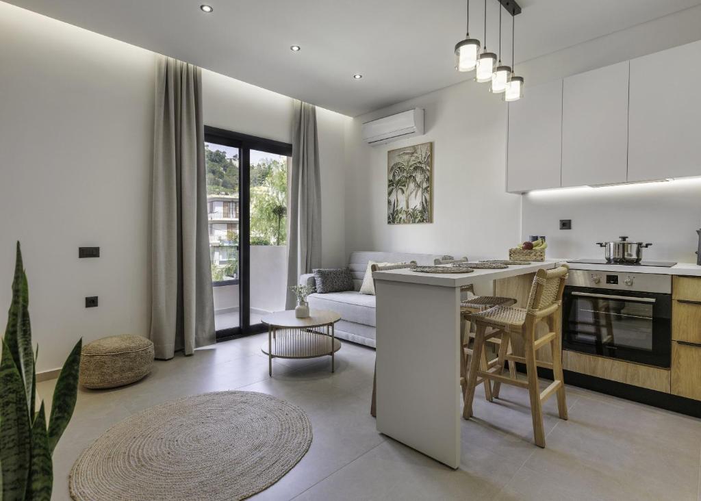 a kitchen and living room with a couch and a table at D'Oliva, by ZanteWize in Zakynthos Town