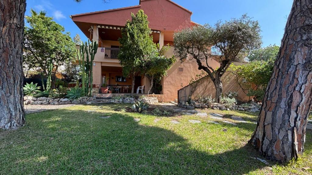 a house with trees in front of it at Villa Amparo con piscina privada in Calafell