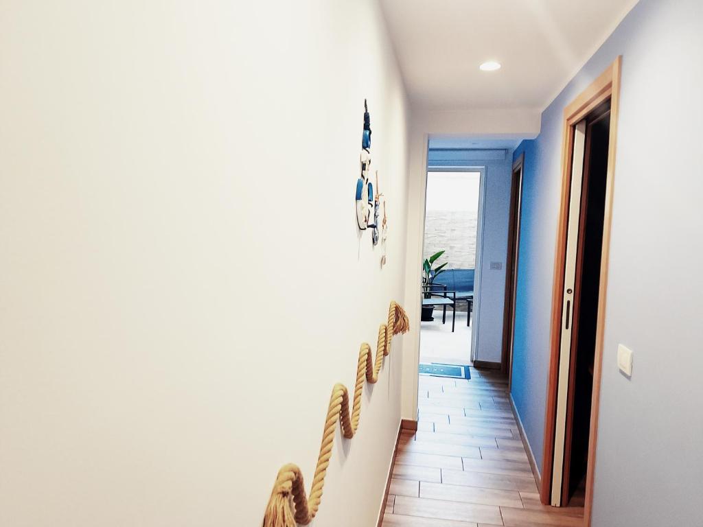 a hallway with a staircase with blue walls at La casa di mamma in Monopoli