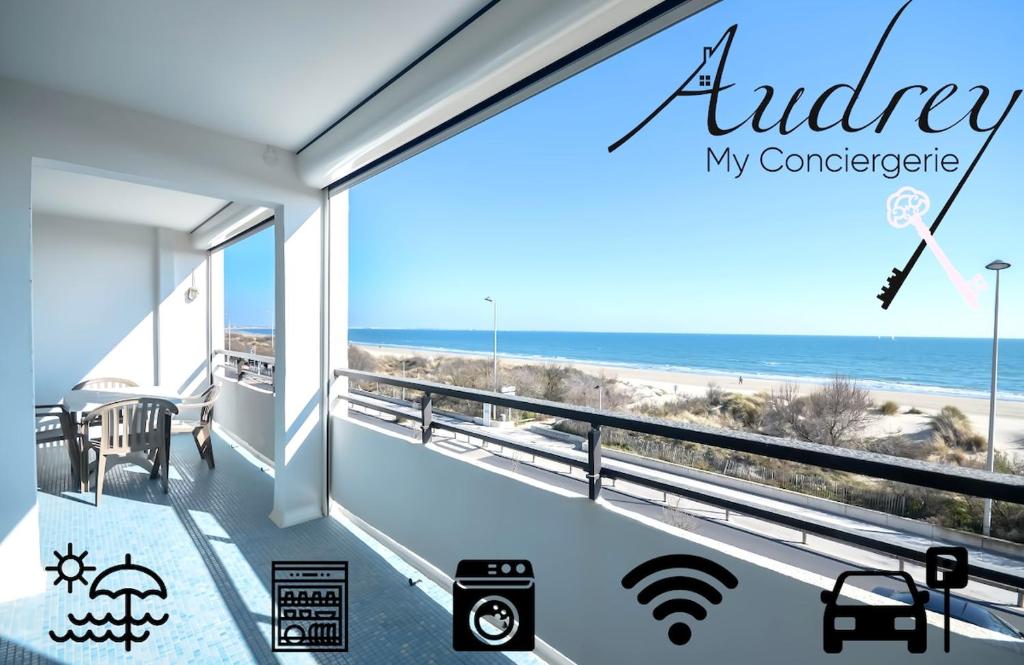a view of the beach from the balcony of a house at Chez Alain - Confortable appartement et vue à couper le souffle in La Grande-Motte