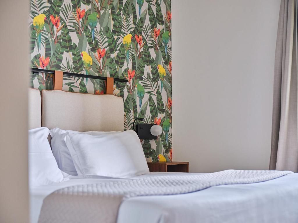 Postel nebo postele na pokoji v ubytování Hotel Carillon