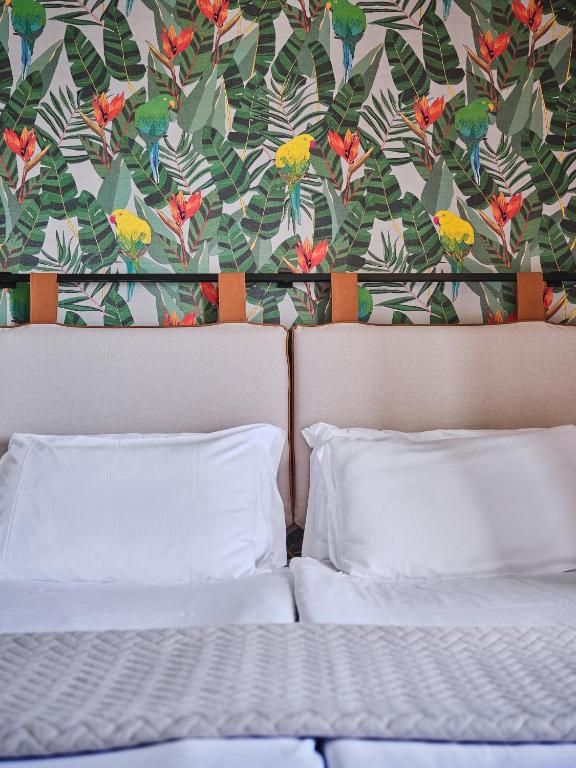 Postel nebo postele na pokoji v ubytování Hotel Carillon