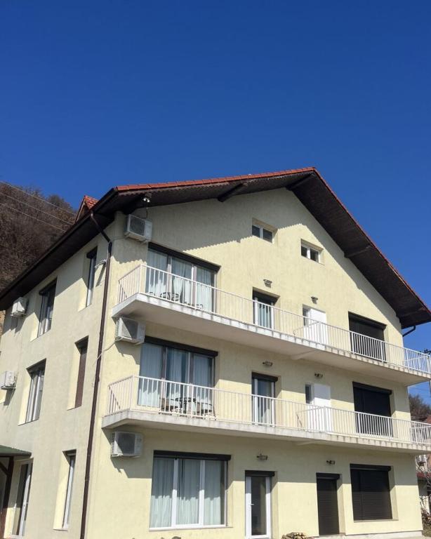 an apartment building with balconies on the side of it at Riviera 990 Chalet in (( Ogradena Nouă ))