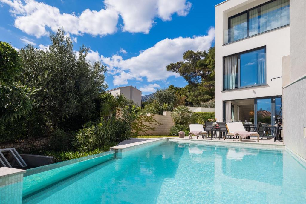 a swimming pool in the backyard of a house at Luxury villa Manera Bol with heated pool near Zlatni Rat in Bol