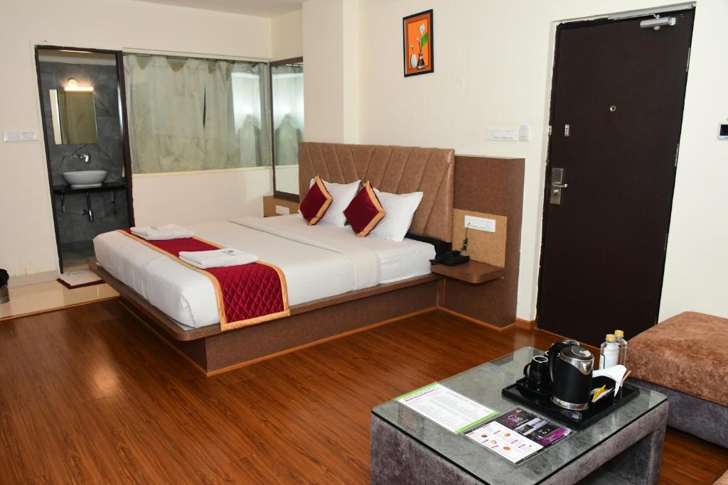 Postel nebo postele na pokoji v ubytování Sai Vihaar Inn & Suites