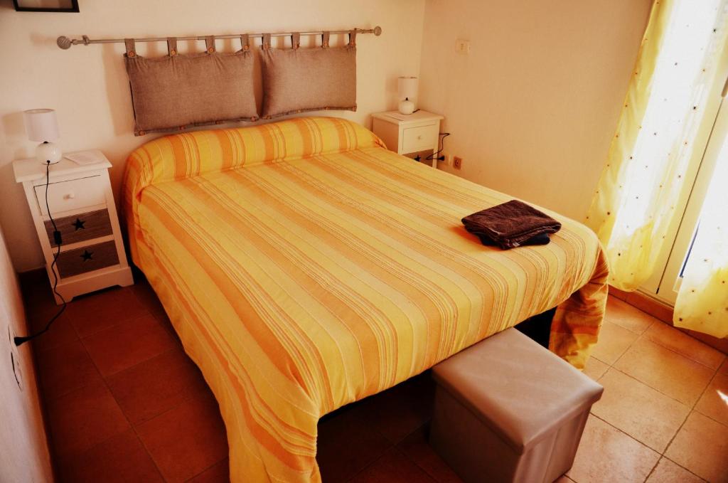 a bedroom with a large bed with a yellow blanket at Antico Castello in Seborga