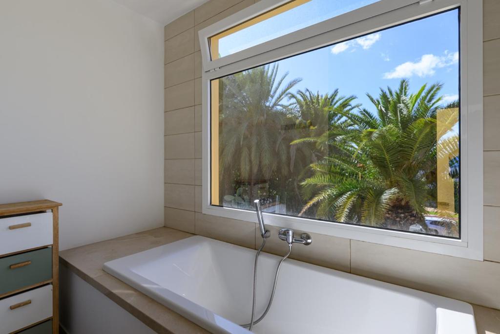 a bathroom with a large sink and a window at Chalet Sol y Beach in San Agustin