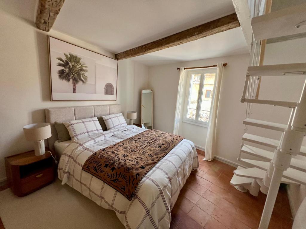 a bedroom with a large bed and a ladder at La bâtisse de Coustouge in Coustouge