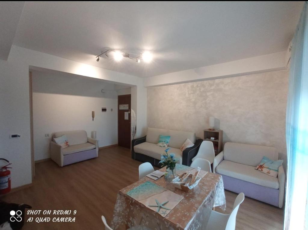 a living room with a couch and a table at Stella Marina in Giardini Naxos