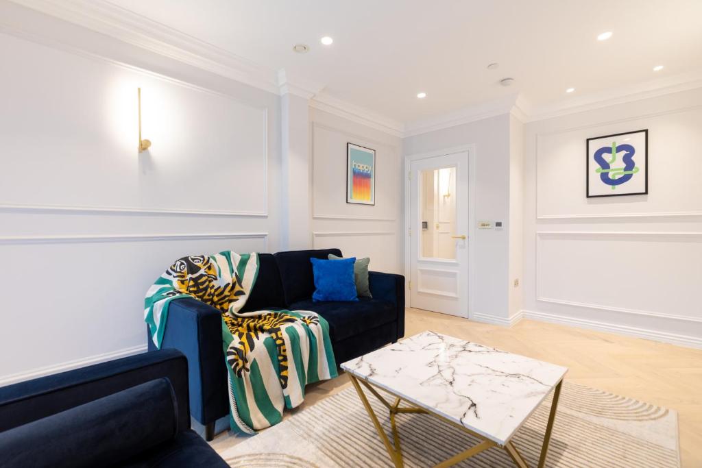 a living room with a couch and a table at Stay Kula London Bridge in London