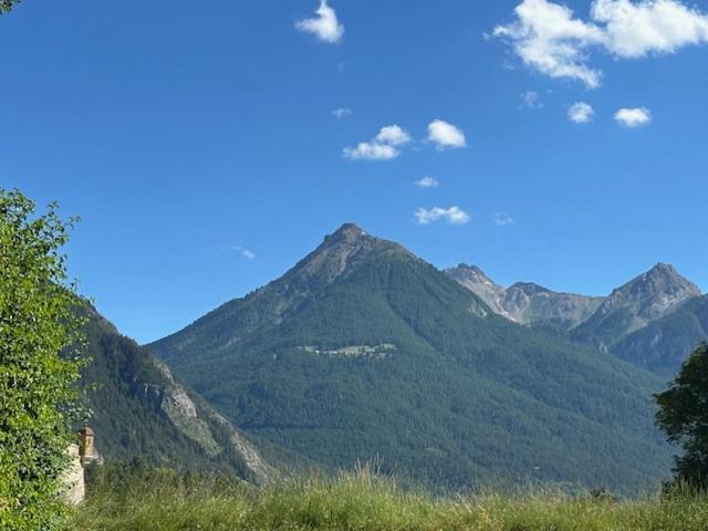 a view of a mountain range with a blue sky at Hôtel Vauban Briançon Serre Chevalier in Briançon