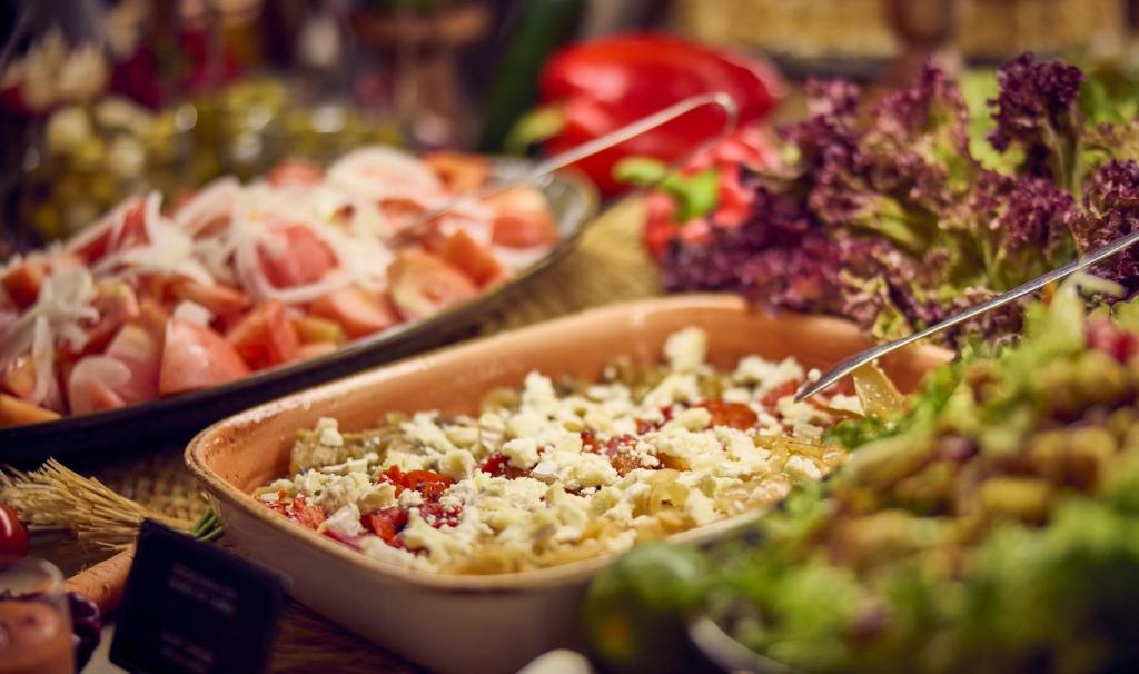 a buffet of different types of food on a table at Cala San Miguel Ibiza Resort, Adults only, Curio Collection by Hilton in Puerto de San Miguel
