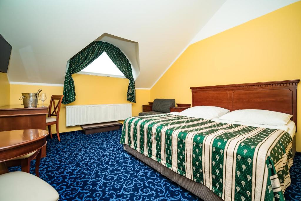 Postel nebo postele na pokoji v ubytování Hotel Otakar