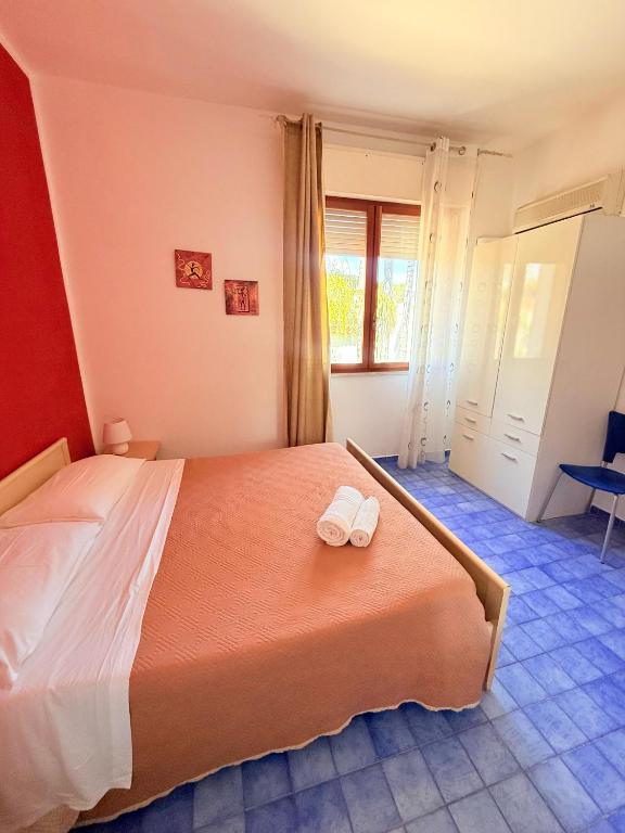Łóżko lub łóżka w pokoju w obiekcie Nido Colorato B&B