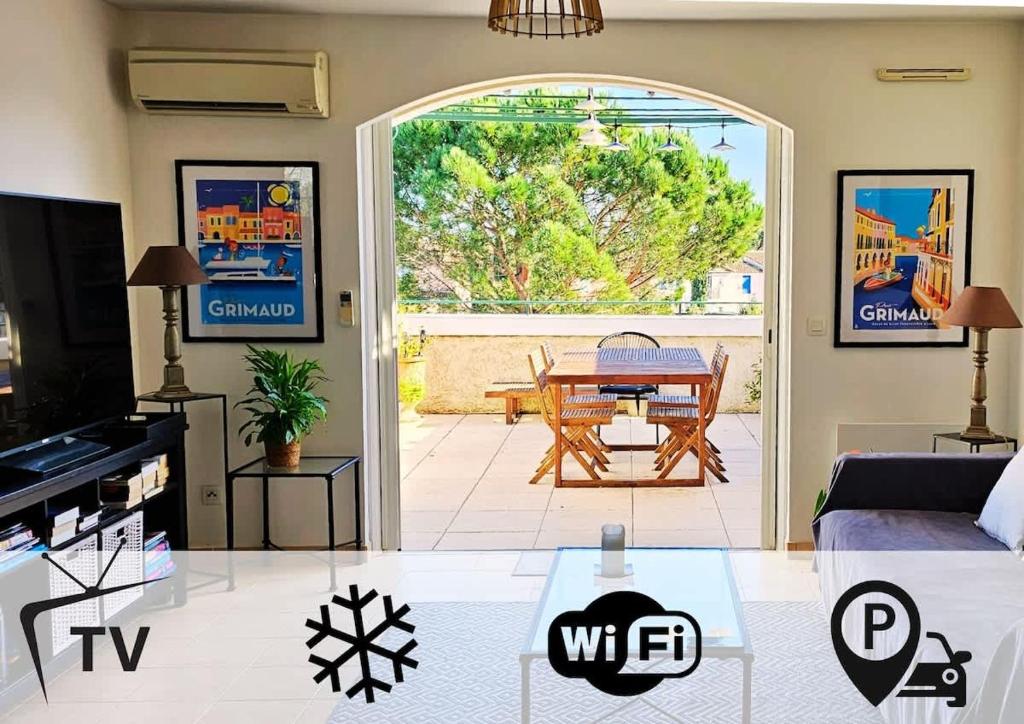 a living room with a couch and a table at Seabird Appartement Lumineux Port Grimaud in Grimaud