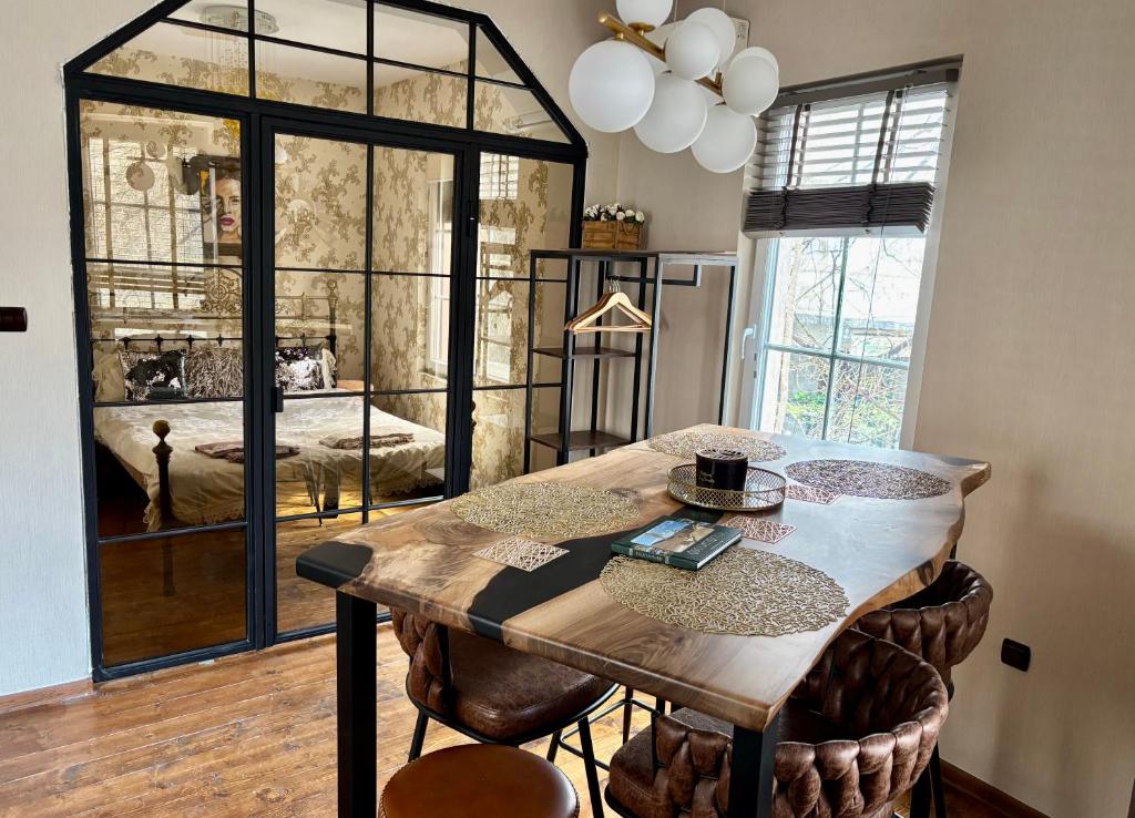 a dining room with a wooden table and chairs at ArtCity Villa- Historic Residence in Kapana in Plovdiv