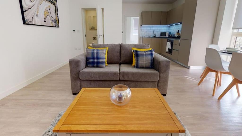 a living room with a couch and a coffee table at Luxury Apartment - Town Centre North Stevenage in Stevenage