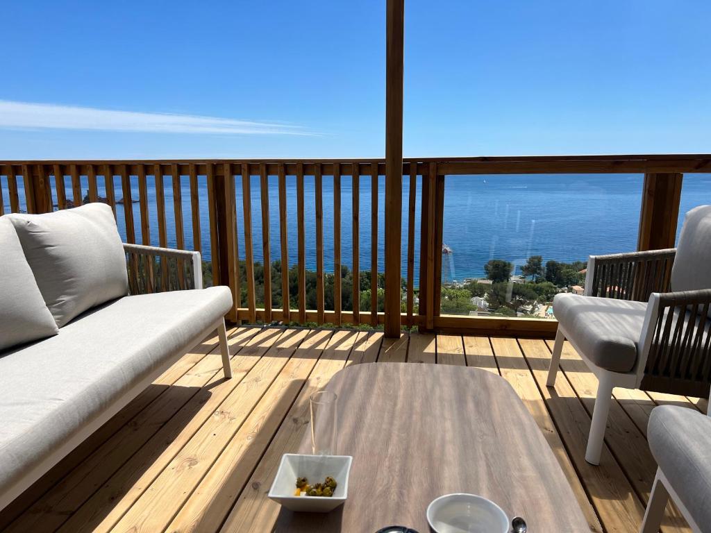 a living room with a couch and a table on a deck at Domaine de l' Ile d' or in La Celle-sous-Gouzon
