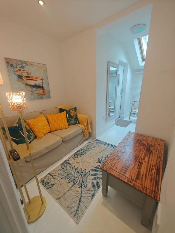 a living room with a couch and a table at Trispin at Sophias in Penzance