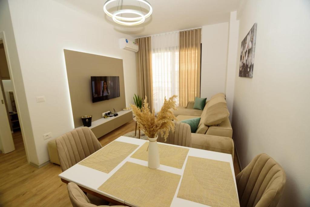 a living room with a table and a couch at Seaside Serenity Apartments - Tirana Resort Radhime in Vlorë