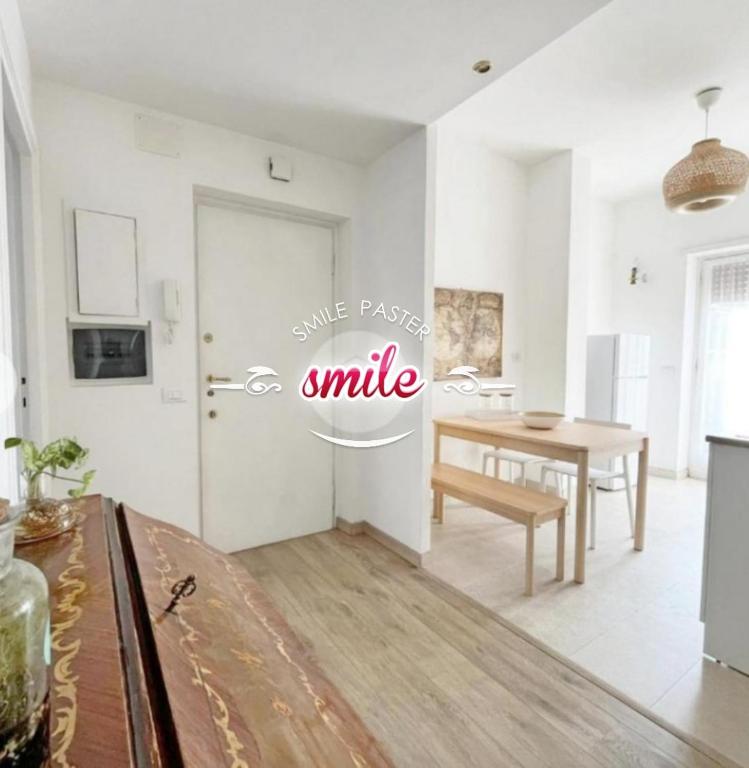 a living room with a table and a white wall at Vacanze romane in Rome