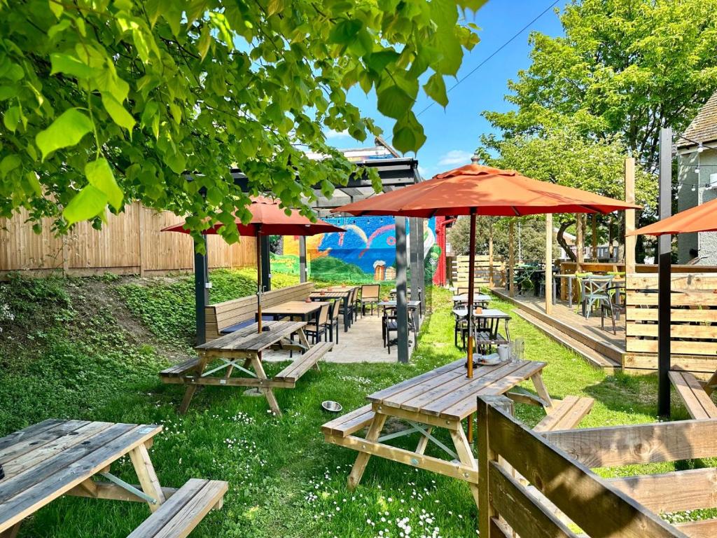 a group of picnic tables with umbrellas at Downs Hotel in Stanmer