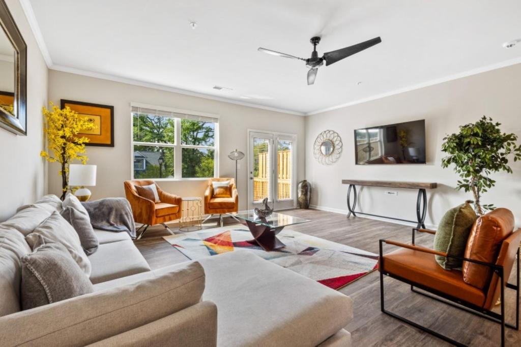 a living room with a couch and a table at Price Cut, New Lux Home 5 mins to Airport , 15 min to Downtown, 25 min to Buckhead with 3 beds and 3 baths in Atlanta