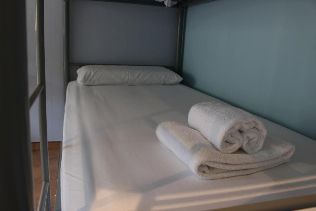 Postel nebo postele na pokoji v ubytování Hotel Al Riu