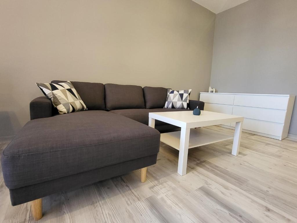 a living room with a couch and a table at Darena apart in Stara Zagora