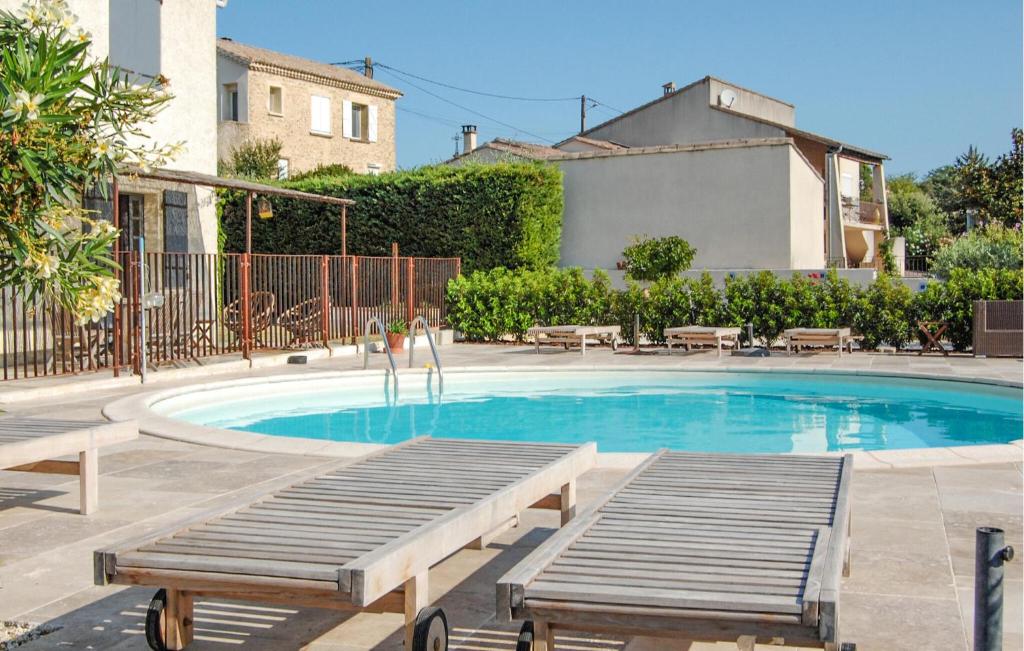 a swimming pool with a wooden ramp next to a house at Amazing Home In Saint Pons La Calm in Saint-Pons-la-Calm