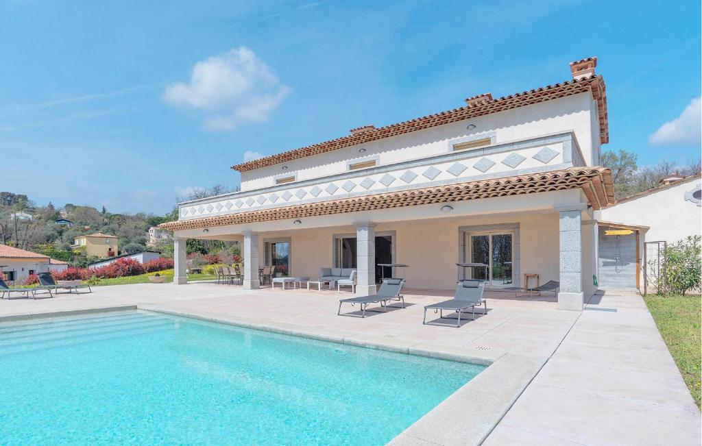 a villa with a swimming pool in front of a house at Splendide Villa Avec Piscine in Saint-Cézaire-sur-Siagne