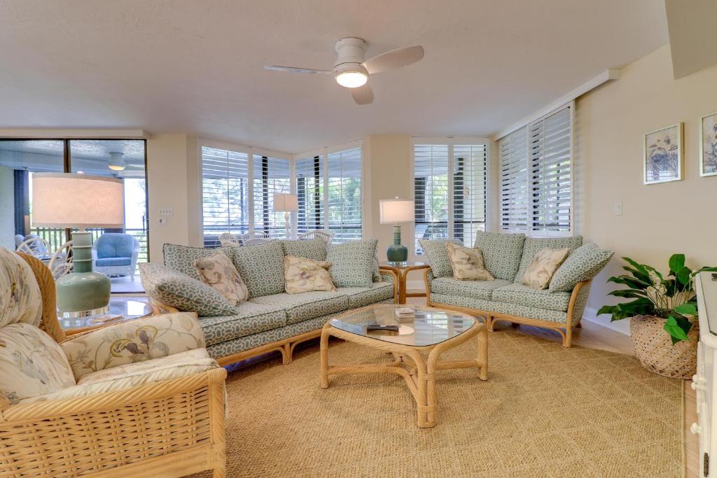a living room with couches and a table at Pine Cove 204 in Sanibel