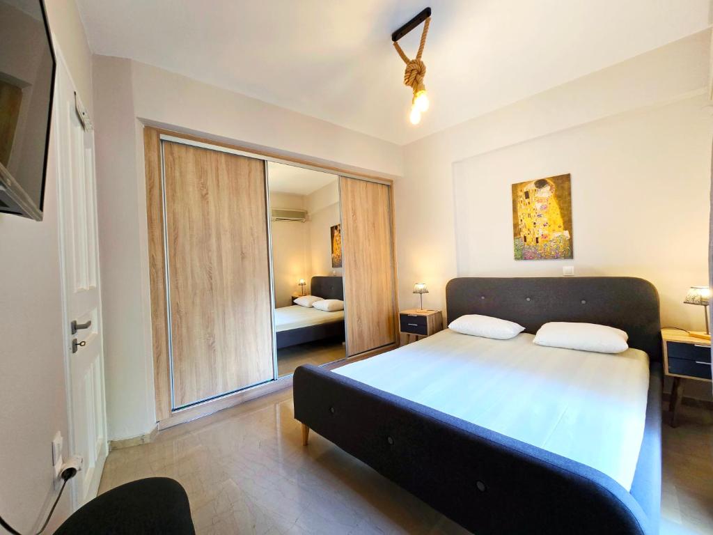 a bedroom with a large bed and a large window at Gemareia Lodge in Lefkada