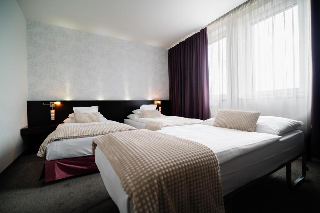 Postel nebo postele na pokoji v ubytování Hotel Turiec